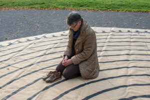 Kneeling on a labyrinth by Jill K H Geoffrion, photographer