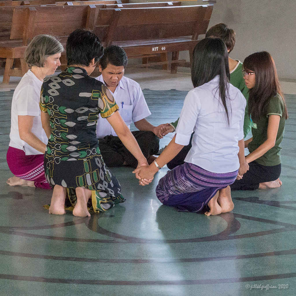Praying together in the center of the labyrinth by Jill K H Geoffrion, Photographer