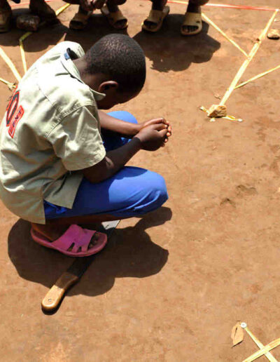 Child praying in the center of the labyrinth in Butembo by photographer Jill K H Geoffrion
